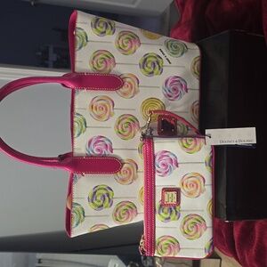 Dooney and bourke medium tote purse. And matching wristlet. Has shouler strap